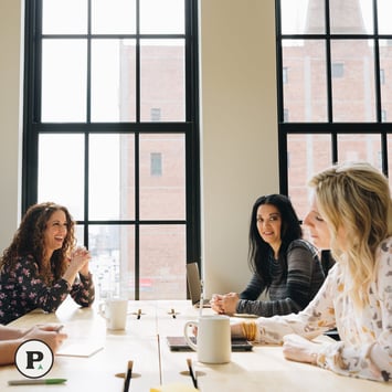 Pioneer team sitting around a table, discussing M&A integration