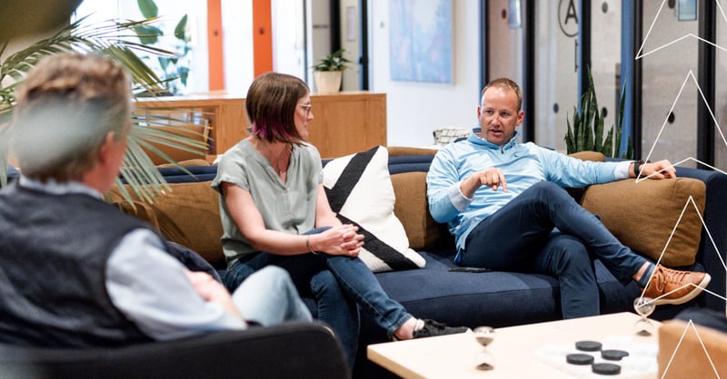 Pioneer team sitting on a couch, talking to one another