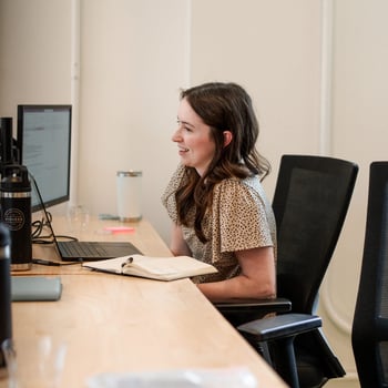 Pioneer employee smiling at her desk