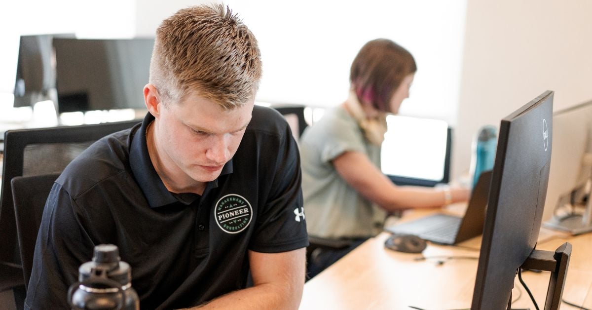 pioneer consulting management team member working on a laptop