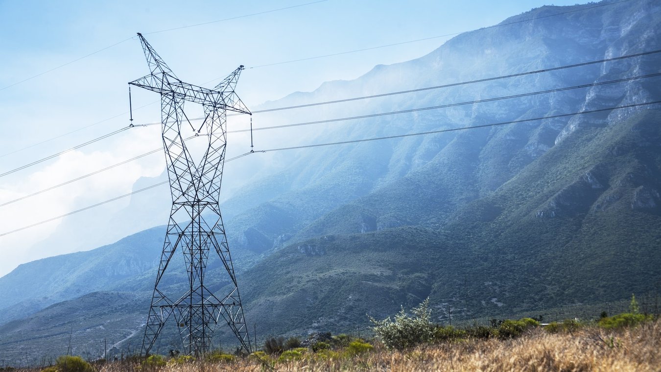 transmission lines in front of mountain