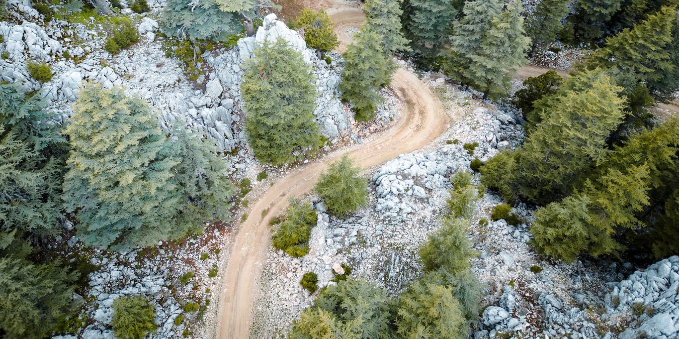Gravel road on a rocky hillside.