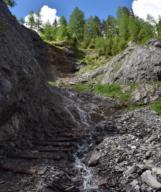 A small stream flowing down a rocky hillside