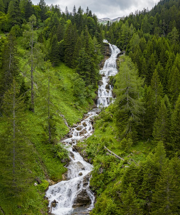 A stream on a green hillside.